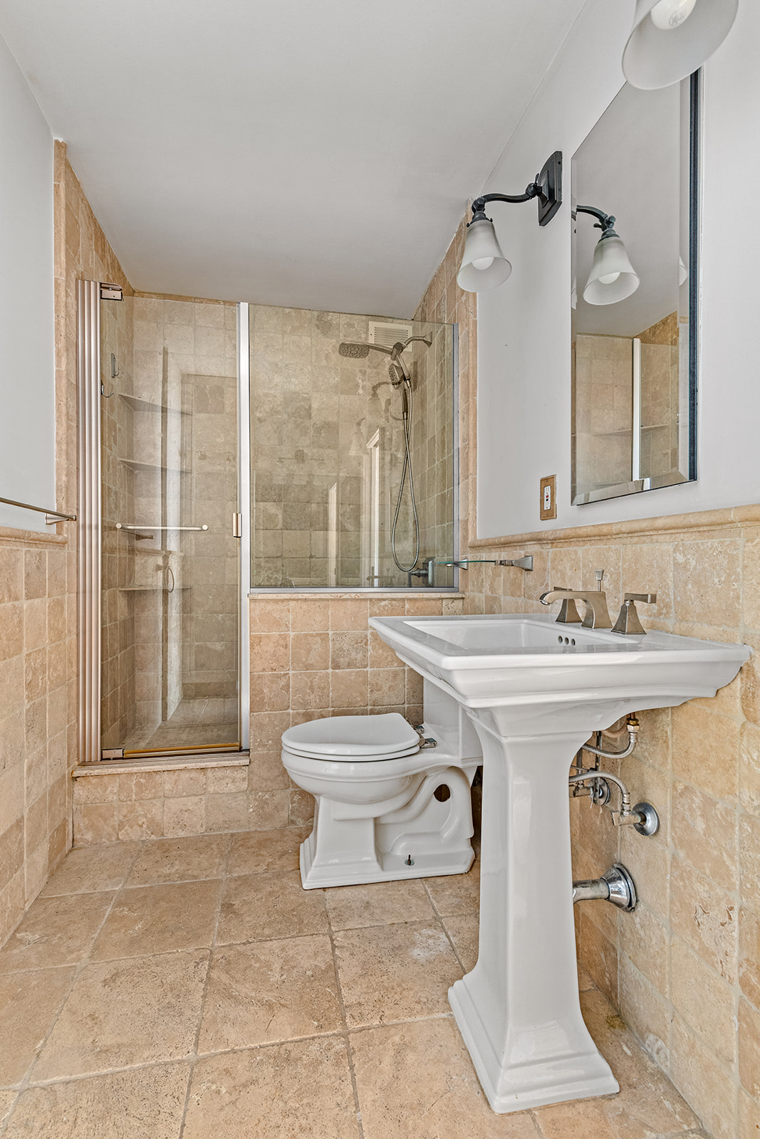 245 East 54th Street, Unit 25ST Manhattan, NY 10022 - Photo 7 of 8 a spacious bathroom with a shower sink and mirror