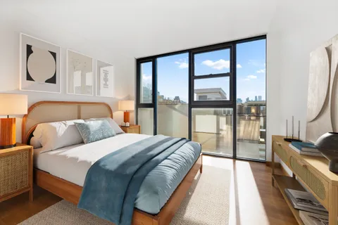 a bedroom with a large bed and a large window