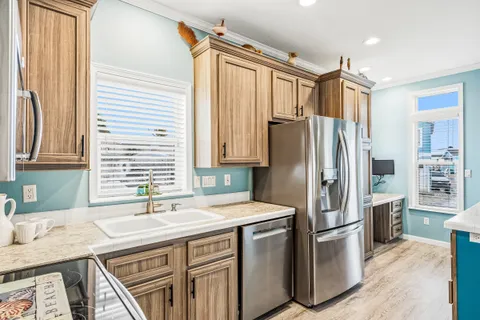 a kitchen with stainless steel appliances a refrigerator and a stove