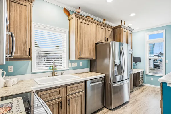 a kitchen with stainless steel appliances a refrigerator and a stove