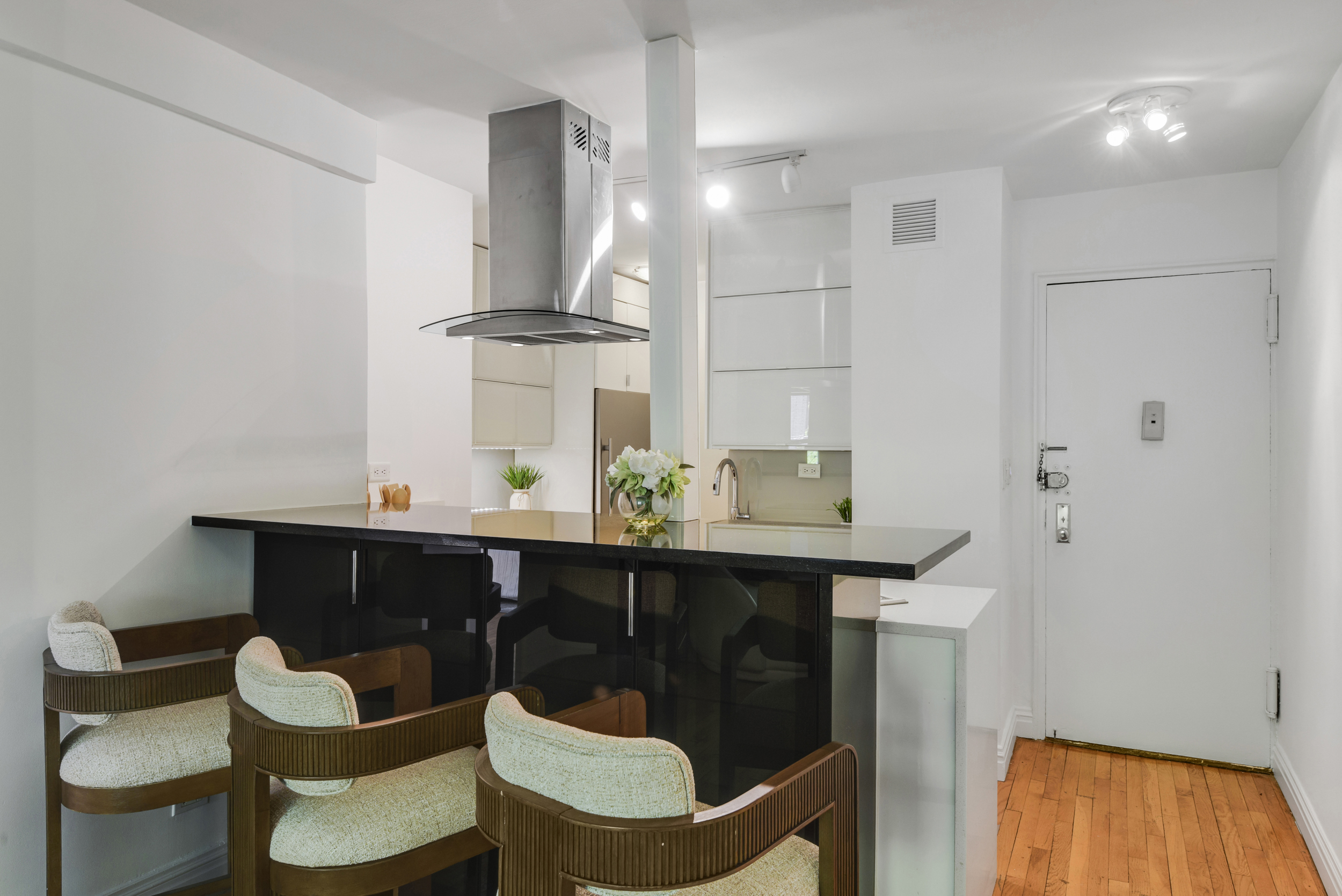 330 East 70th Street, Unit 4F Manhattan, NY 10021 - Photo 5 of 14 a kitchen with a sink cabinets and wooden floor