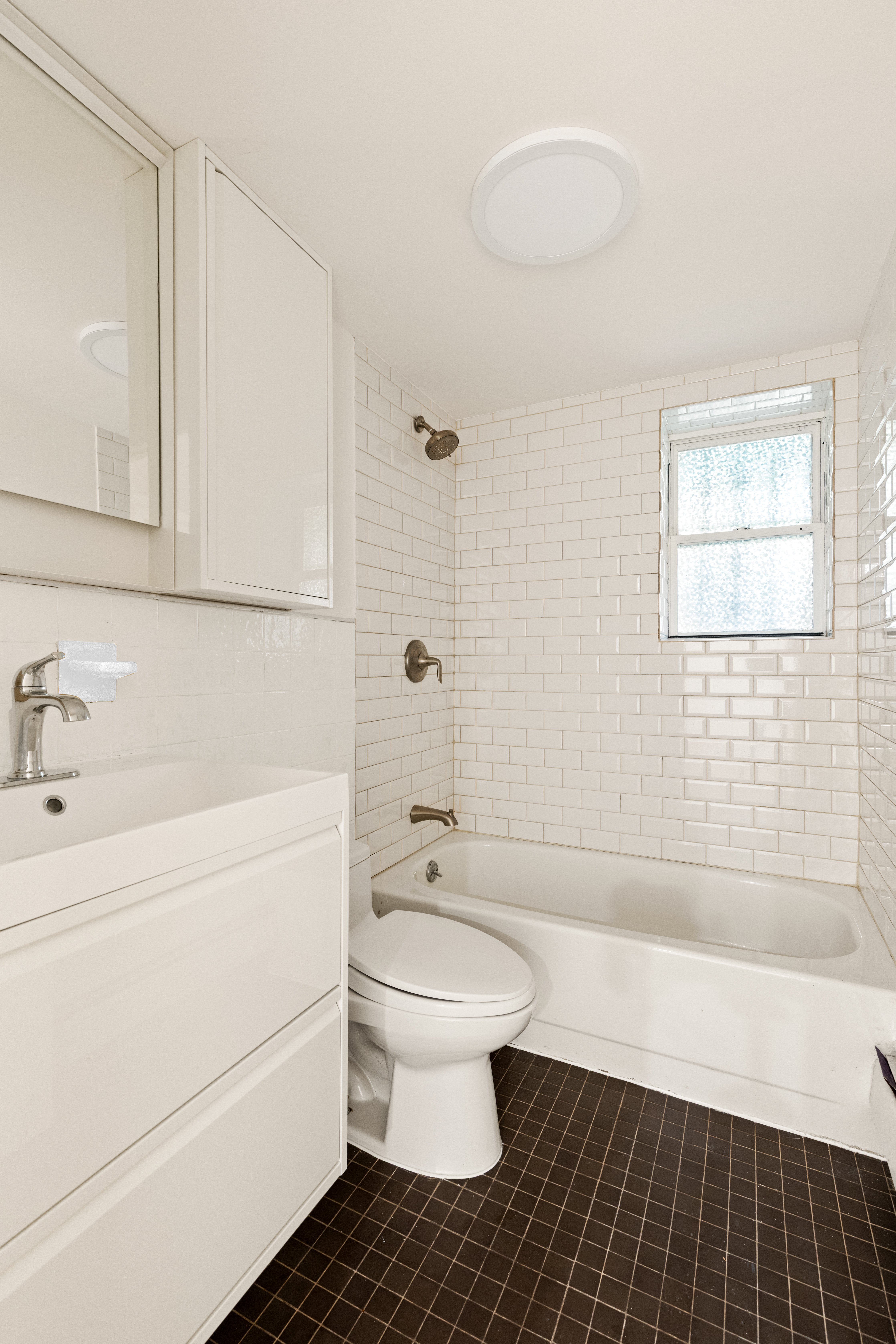 341 Adelphi Street, Unit 1 Brooklyn, NY 11238 - Photo 6 of 7 a bathroom with a sink a toilet and shower