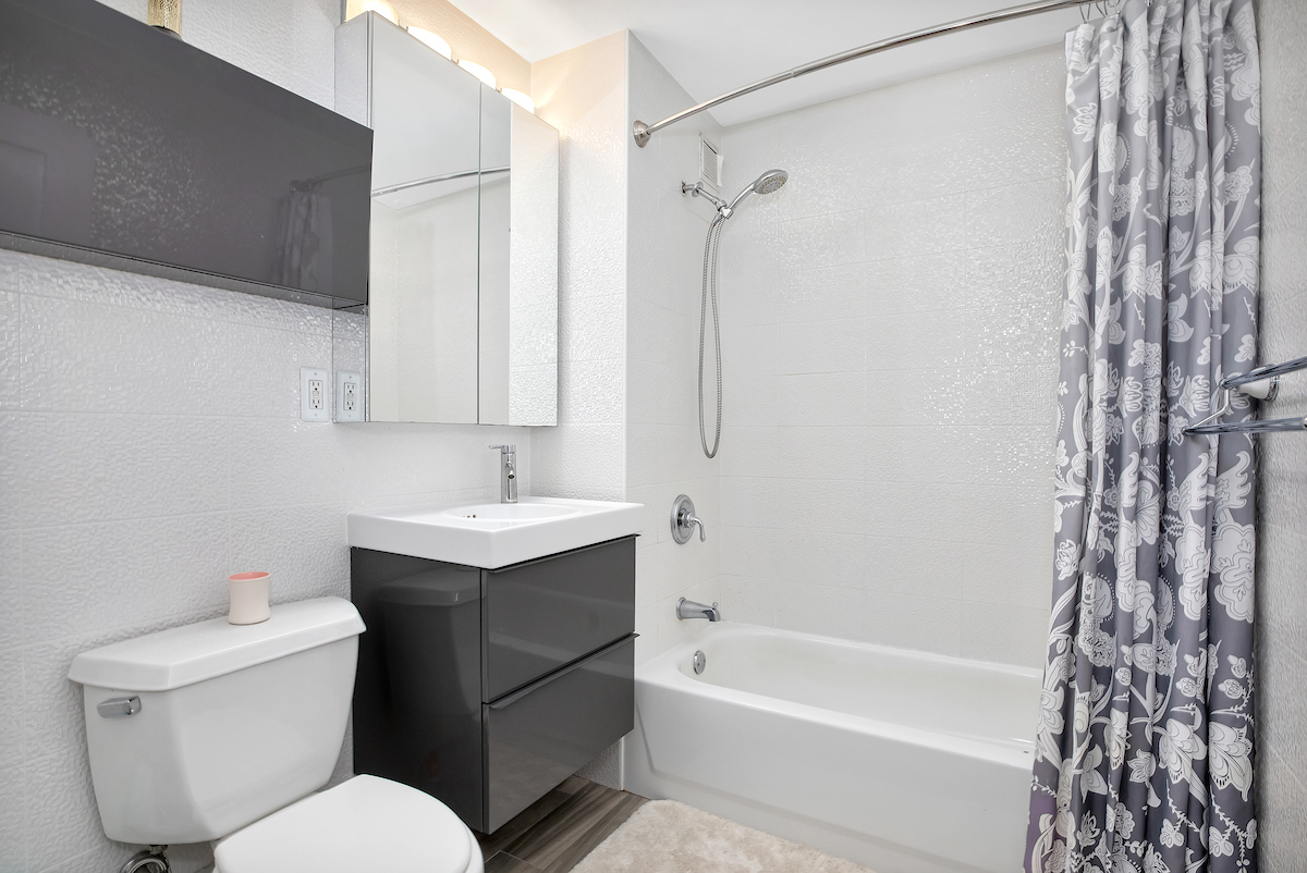 1400 5th Avenue, Unit 8J Manhattan, NY 10026 - Photo 3 of 8 a bathroom with a sink toilet vanity and shower