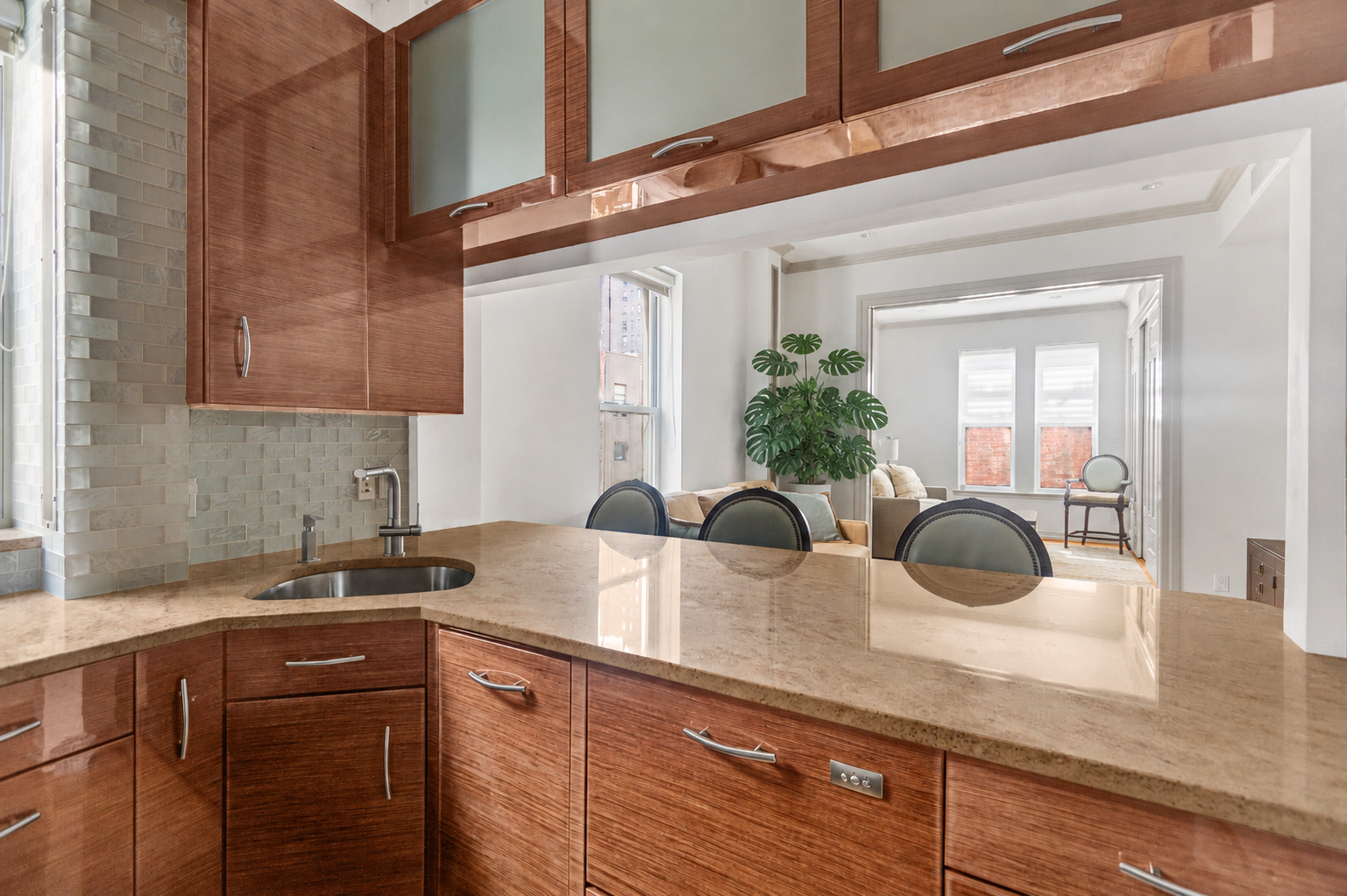 345 West 70th Street, Unit 4E Manhattan, NY 10023 - Photo 5 of 11 a kitchen with a granite countertop sink a potted plant and a window