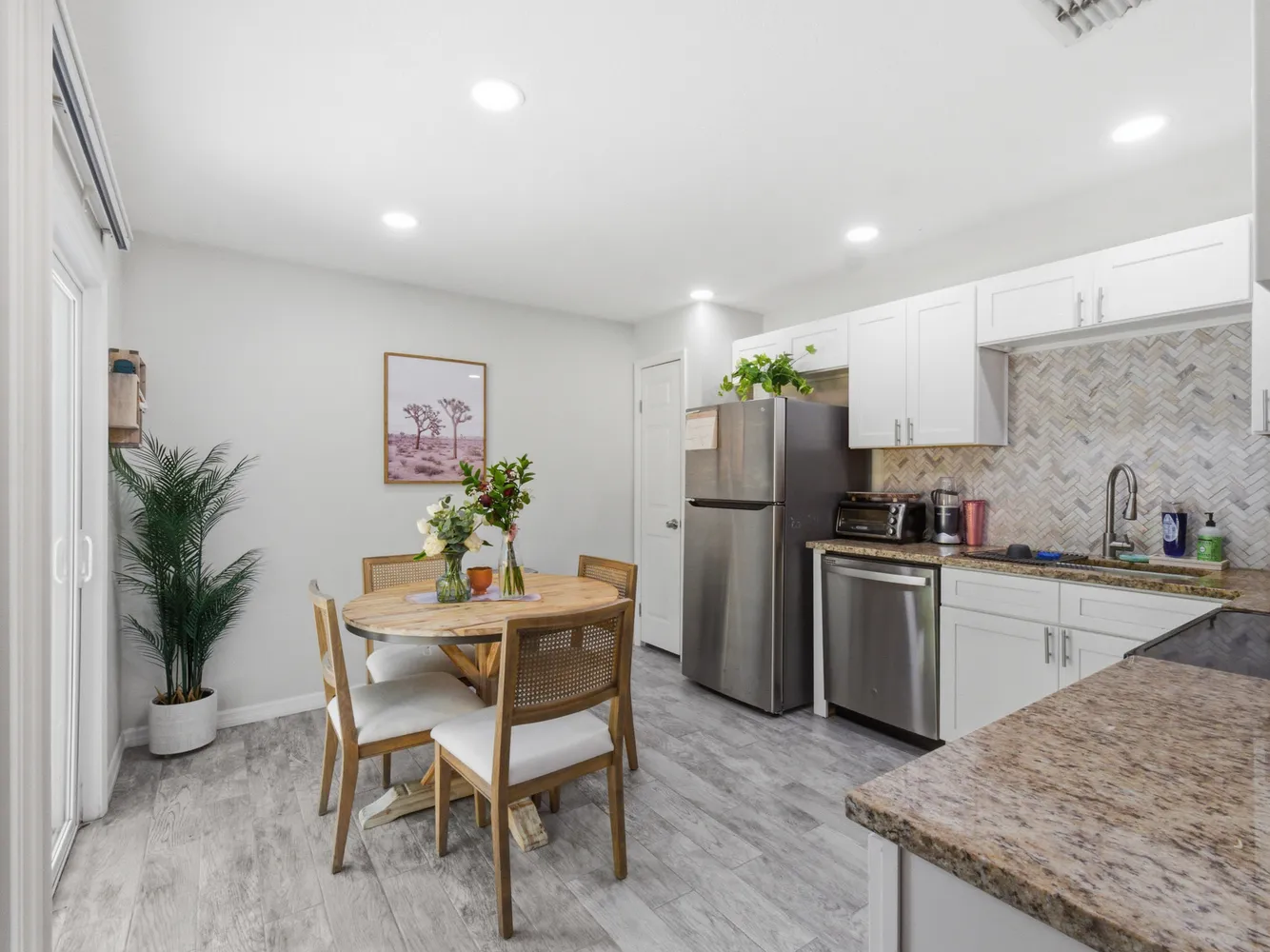 a kitchen with refrigerator and chairs