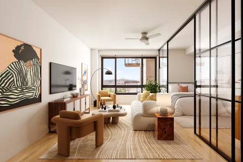 a living room with furniture and a floor to ceiling window