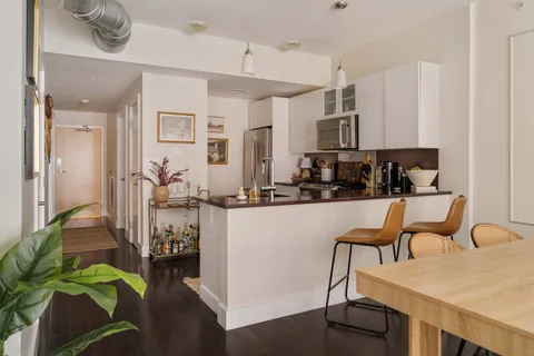 a kitchen with a table chairs stove and cabinets