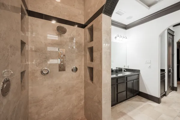 a bathroom with a granite countertop shower mirror and a sink