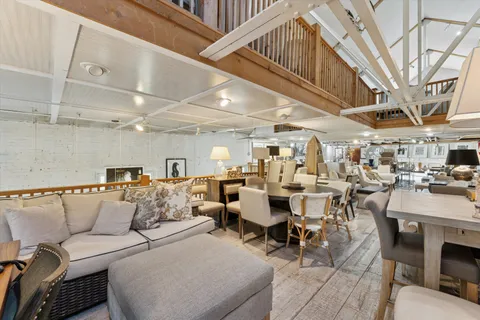 a living room with lots of furniture and a chandelier