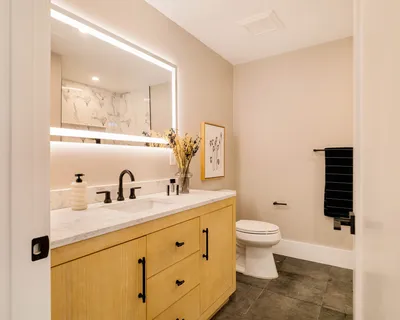 a bathroom with a sink a toilet and shower