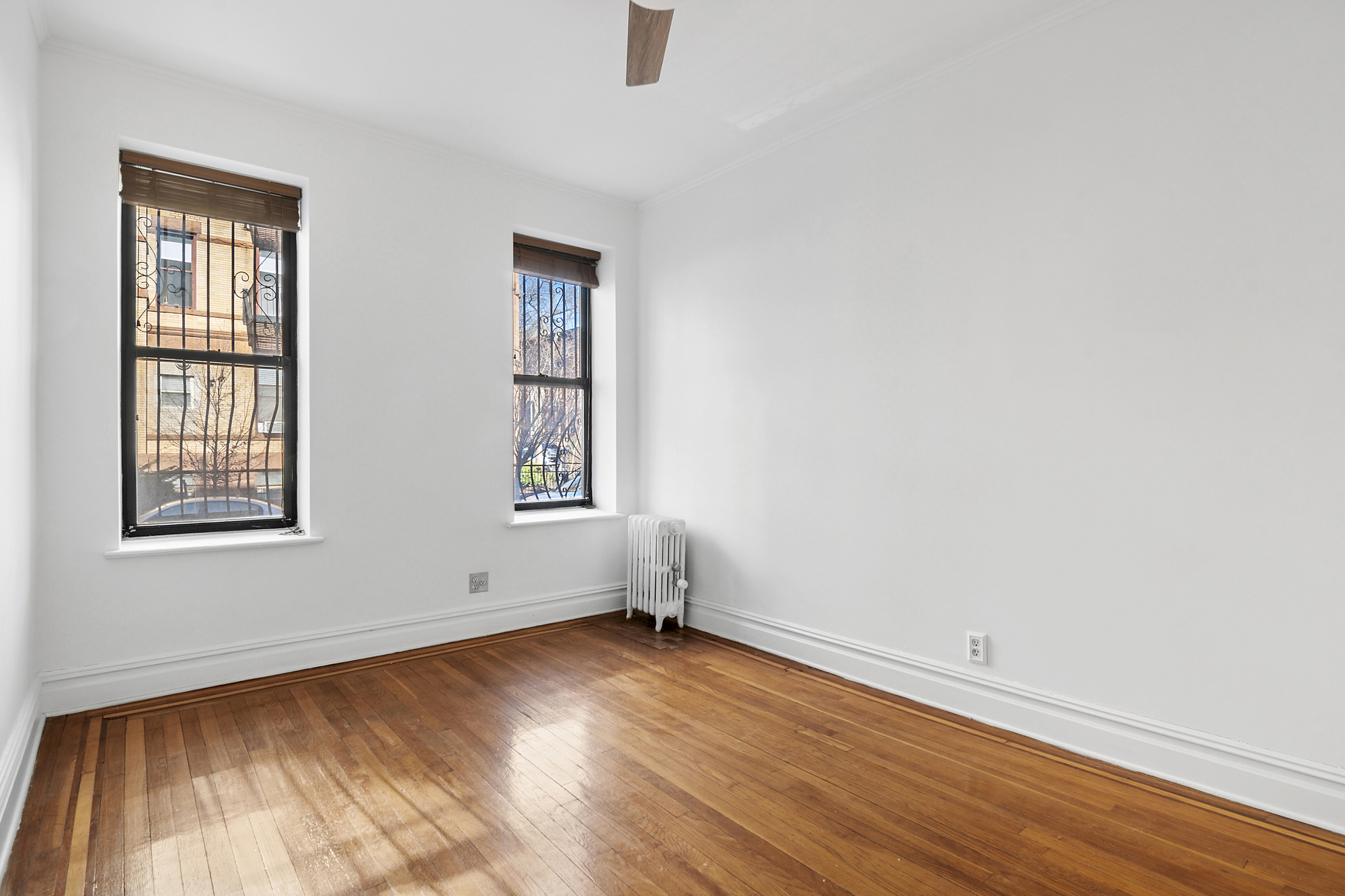 264 6th Avenue, Unit 1C Brooklyn, NY 11215 - Photo 7 of 11 an empty room with wooden floor and windows