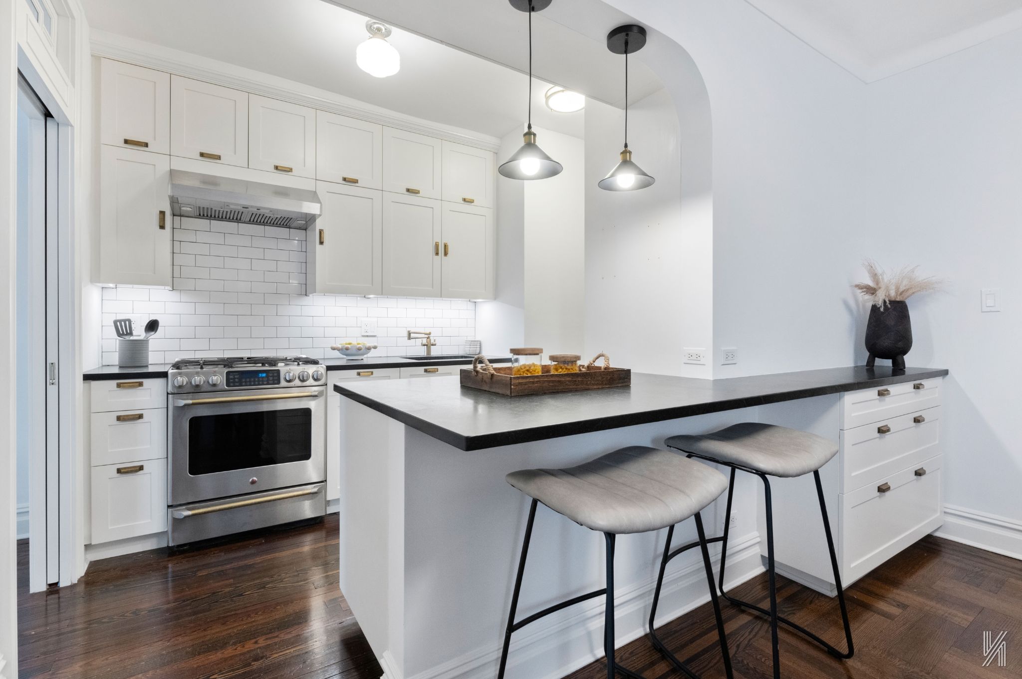 35-06 88th Street, Unit 5E Queens, NY 11372 - Photo 5 of 21 a kitchen with a stove cabinets and wooden floor
