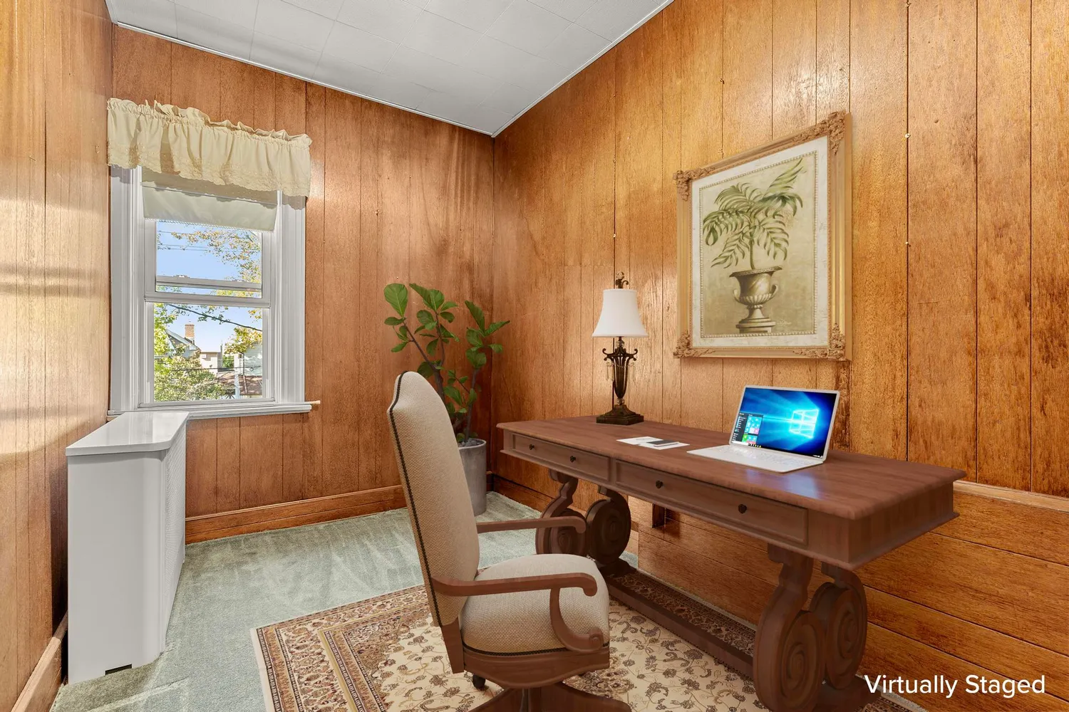 a view of a workspace with furniture and a window