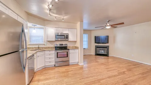 a kitchen with stainless steel appliances a stove a refrigerator sink and cabinets