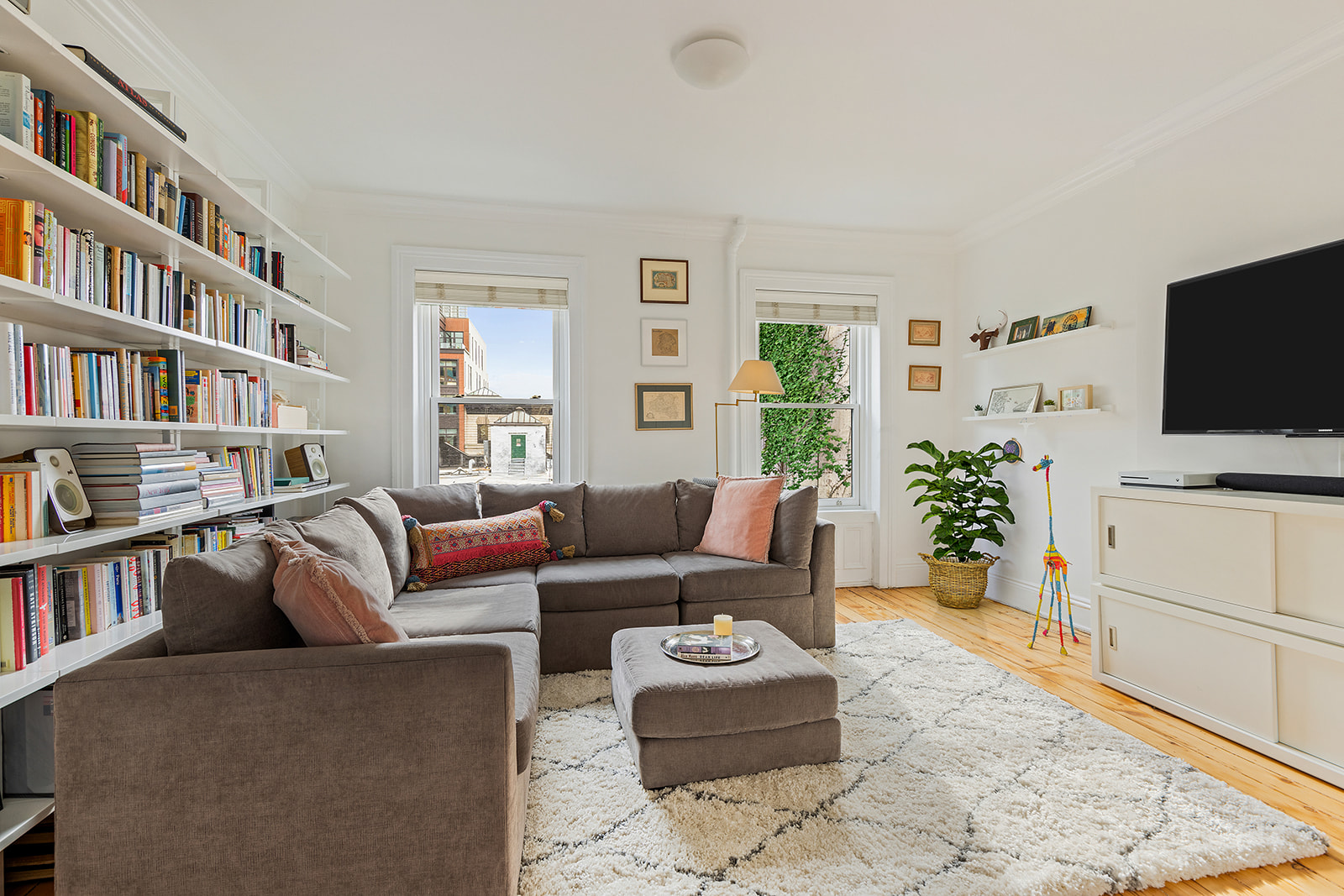 146 Berkeley Place Brooklyn, NY 11217 - Photo 9 of 21 a living room with furniture and a flat screen tv