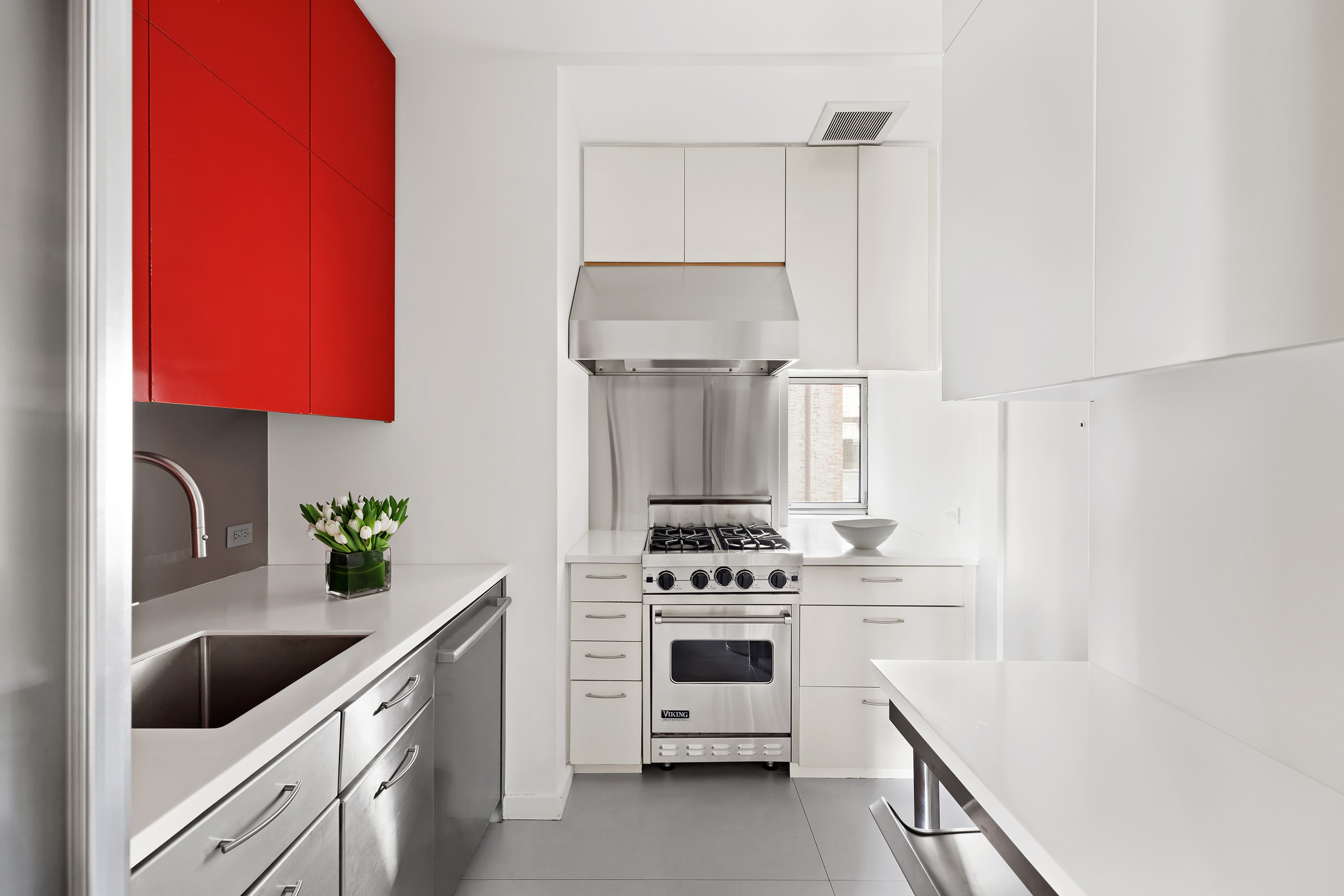863 Park Avenue, Unit 8W Manhattan, NY 10075 - Photo 5 of 15 a kitchen with white cabinets and white appliances