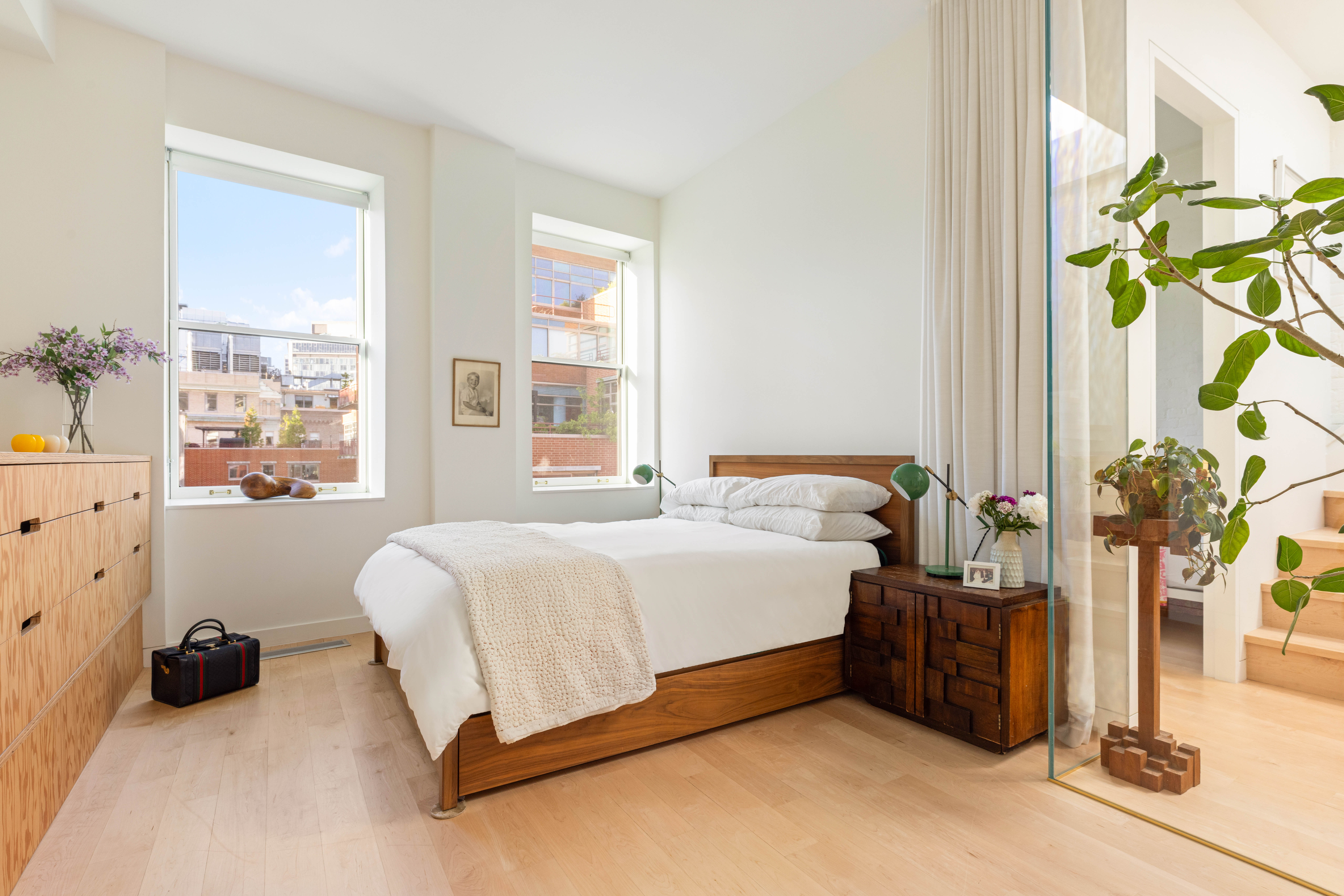 130 Jane Street, Unit 5/6F Manhattan, NY 10014 - Photo 15 of 23 a bedroom with a bed table and a window