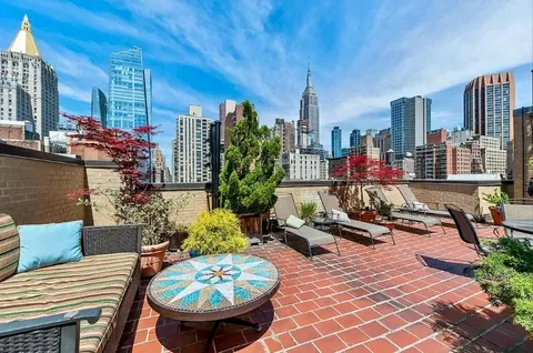 a view of a patio with couches and potted plants
