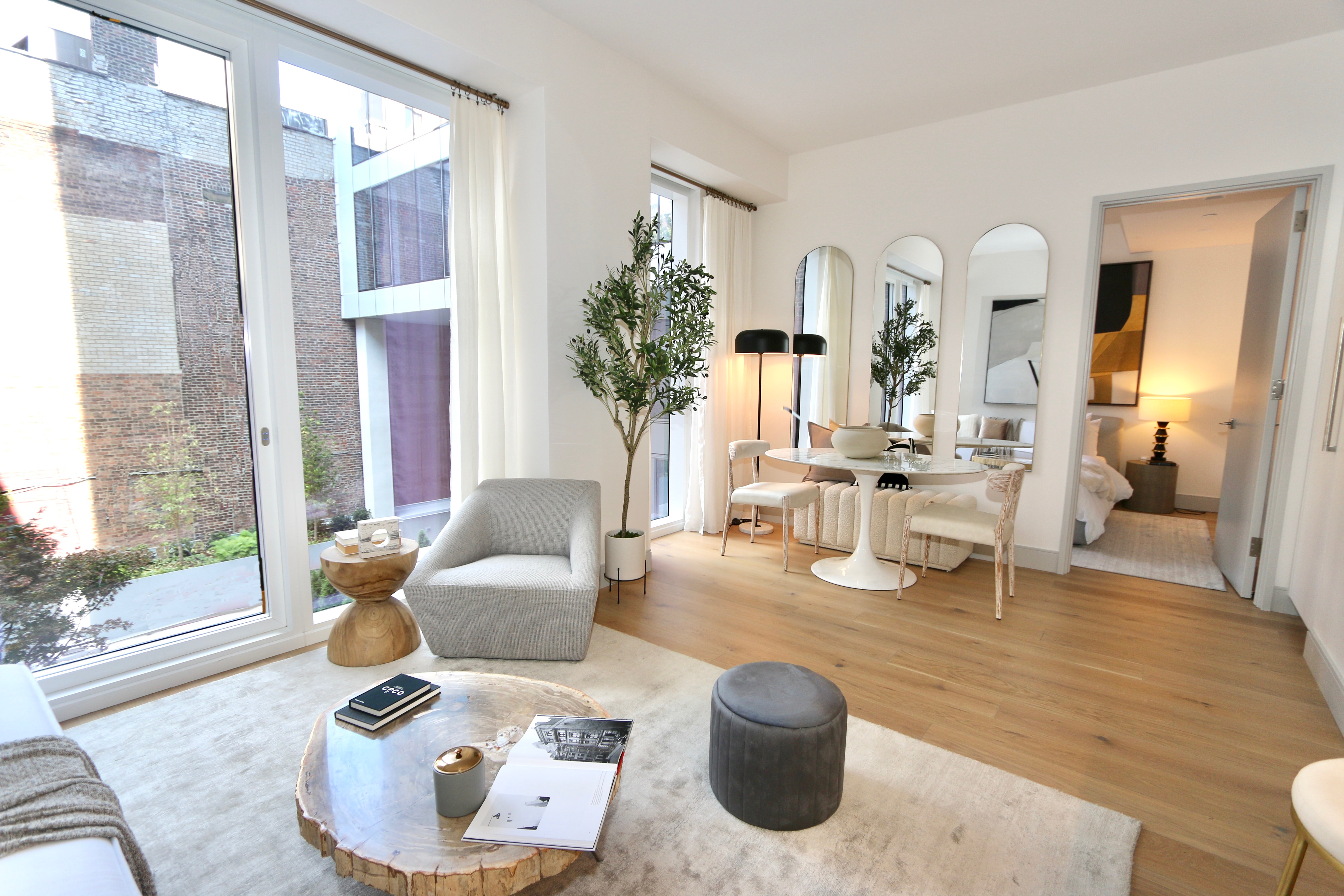 101 West 14th Street, Unit 3D Manhattan, NY 10011 - Photo 2 of 14 a living room with furniture and a large window