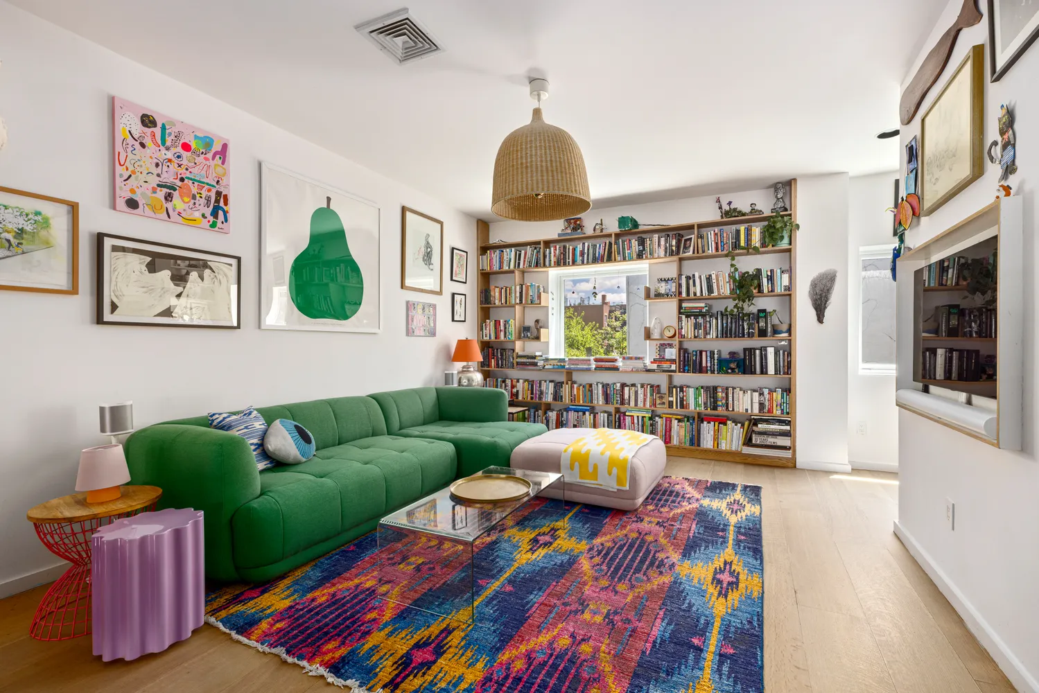 a living room with furniture and a book shelf