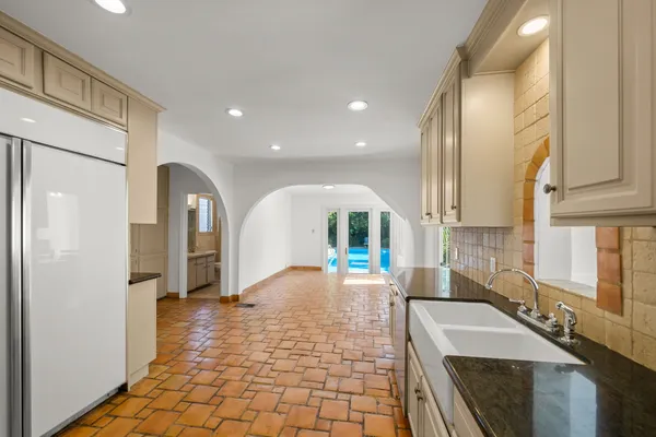 a open kitchen with stainless steel appliances granite countertop a sink and a refrigerator