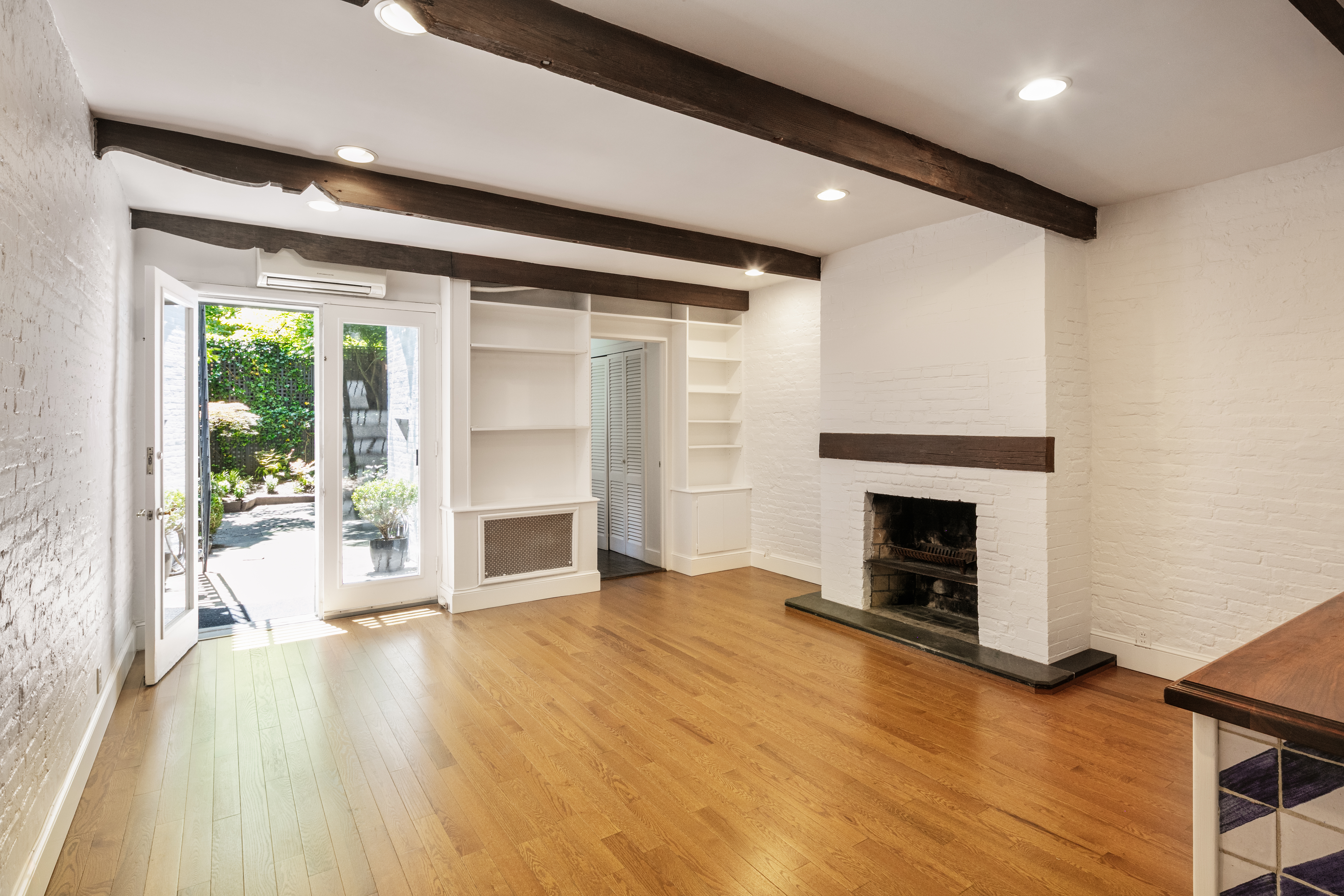 112 West 78th Street, Unit PARLOR Manhattan, NY 10024 - Photo 15 of 37 a view of an empty room with a fireplace and a window