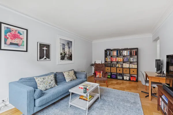 a living room with furniture workspace and a bookshelf