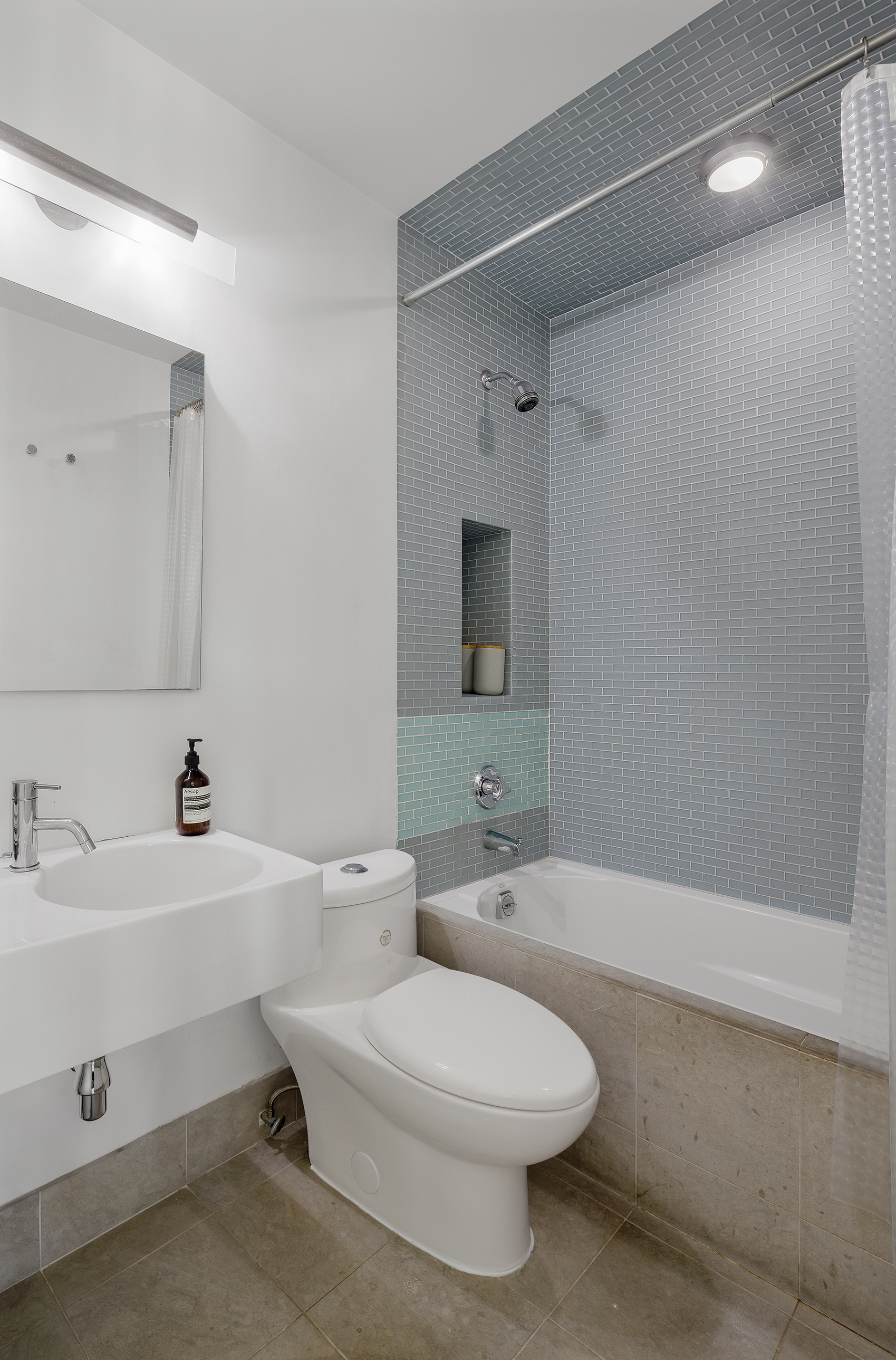 181 7th Avenue, Unit 11A Manhattan, NY 10011 - Photo 8 of 13 a bathroom with a toilet a sink and bathtub