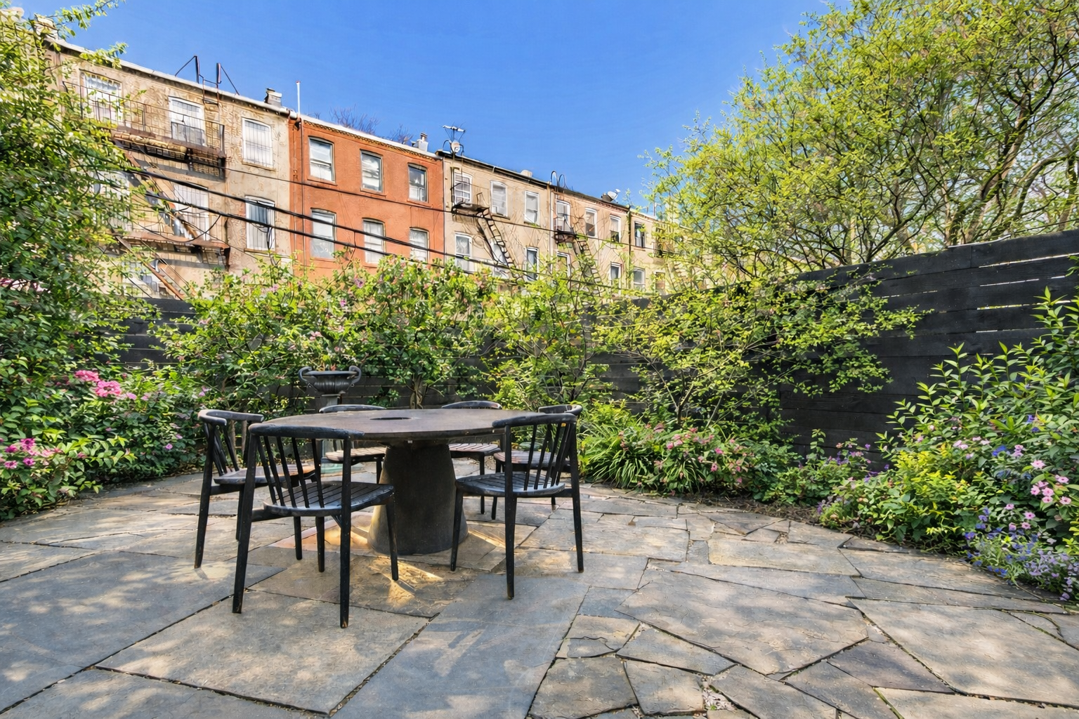 191 MacDonough Street, Unit 2 Brooklyn, NY 11216 - Photo 4 of 7 a patio with table and chairs and potted plants