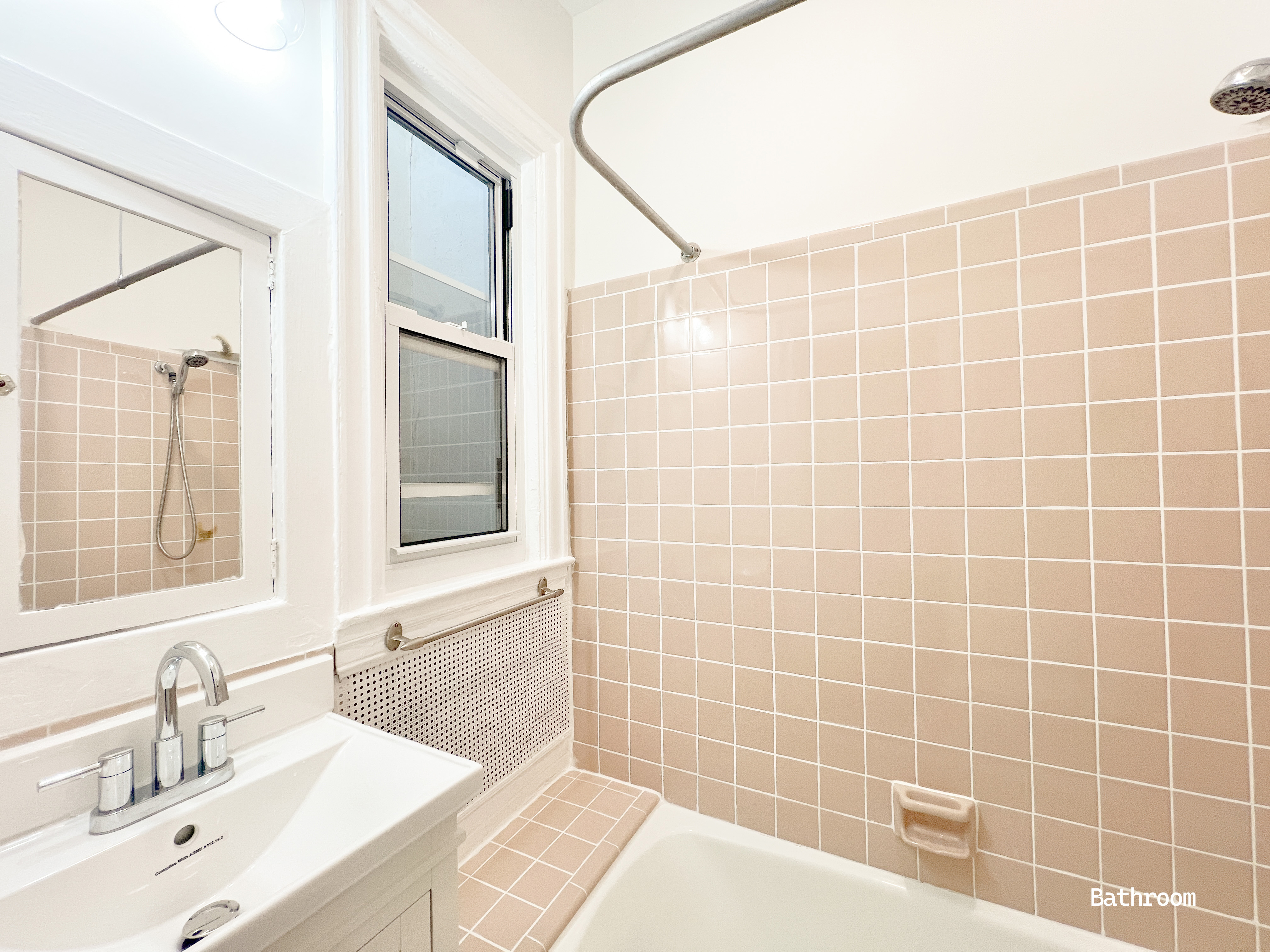 271 71st Street, Unit 2 Brooklyn, NY 11209 - Photo 8 of 10 a bathroom with a sink mirror and a shower