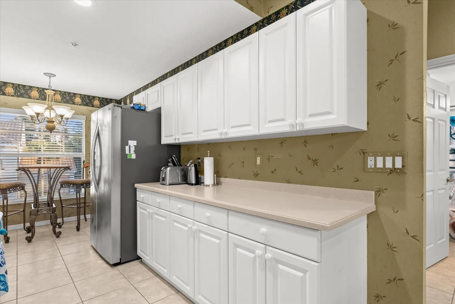 a view of a dining room with furniture and chandelier