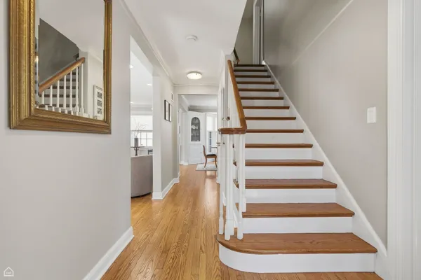 a view of entryway and hall with wooden floor