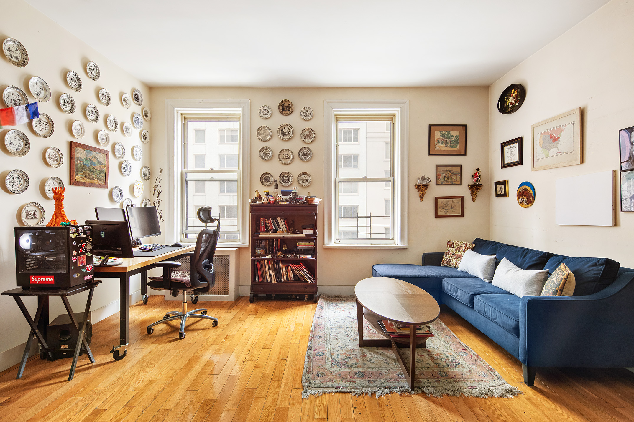 57 West 58th Street, Unit 8A Manhattan, NY 10019 - Photo 2 of 8 a living room with furniture and a large window