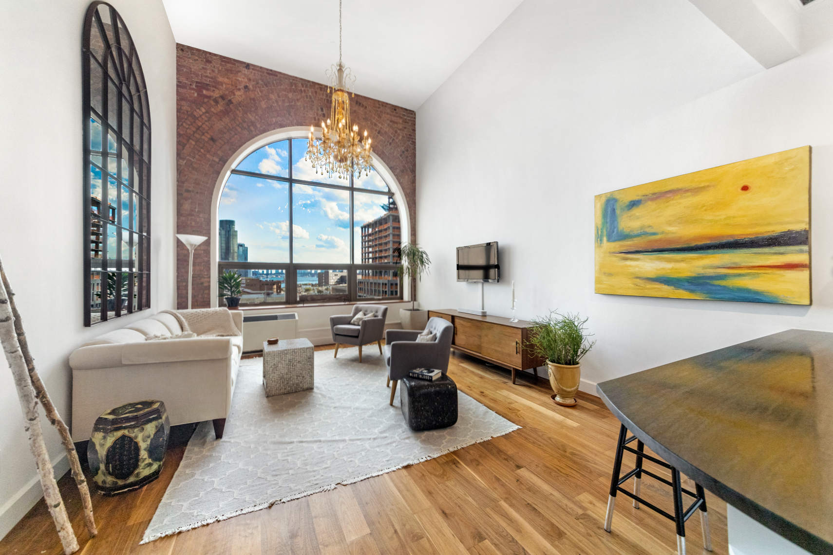 a living room with fireplace furniture and a large window