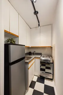 a kitchen with a stove a refrigerator and a sink