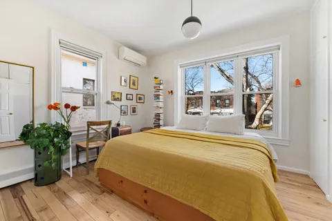 a bedroom with a large bed and a window
