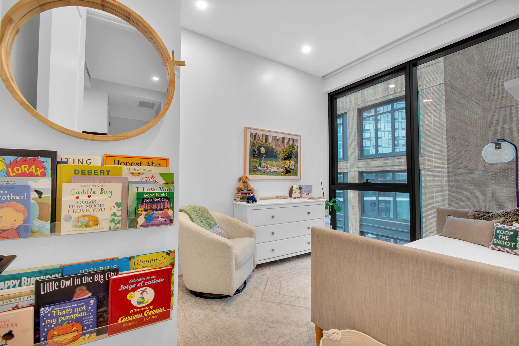 5 Court Square West, Unit 8A Queens, NY 11101 - Photo 2 of 7 a living room with furniture a rug and a large mirror