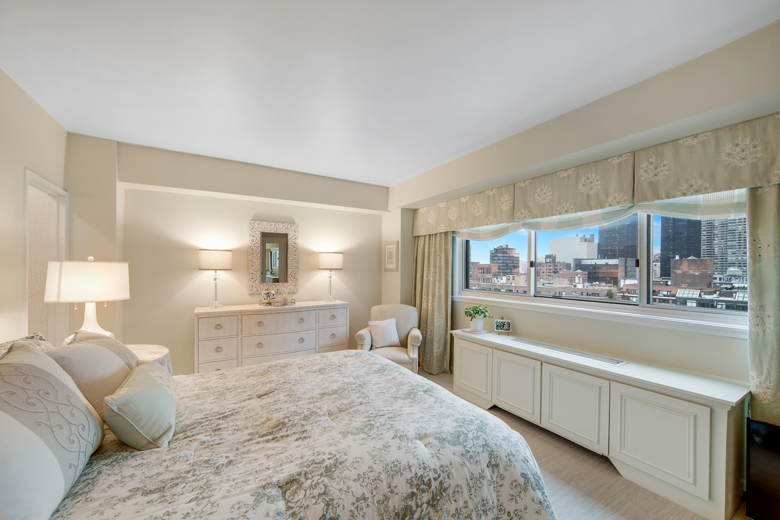 401 East 65th Street, Unit 16C Manhattan, NY 10065 - Photo 6 of 13 a bedroom with a bed and wooden floor