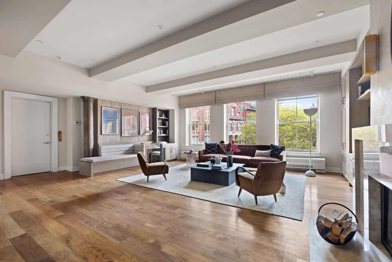 a living room with furniture large window and a fireplace