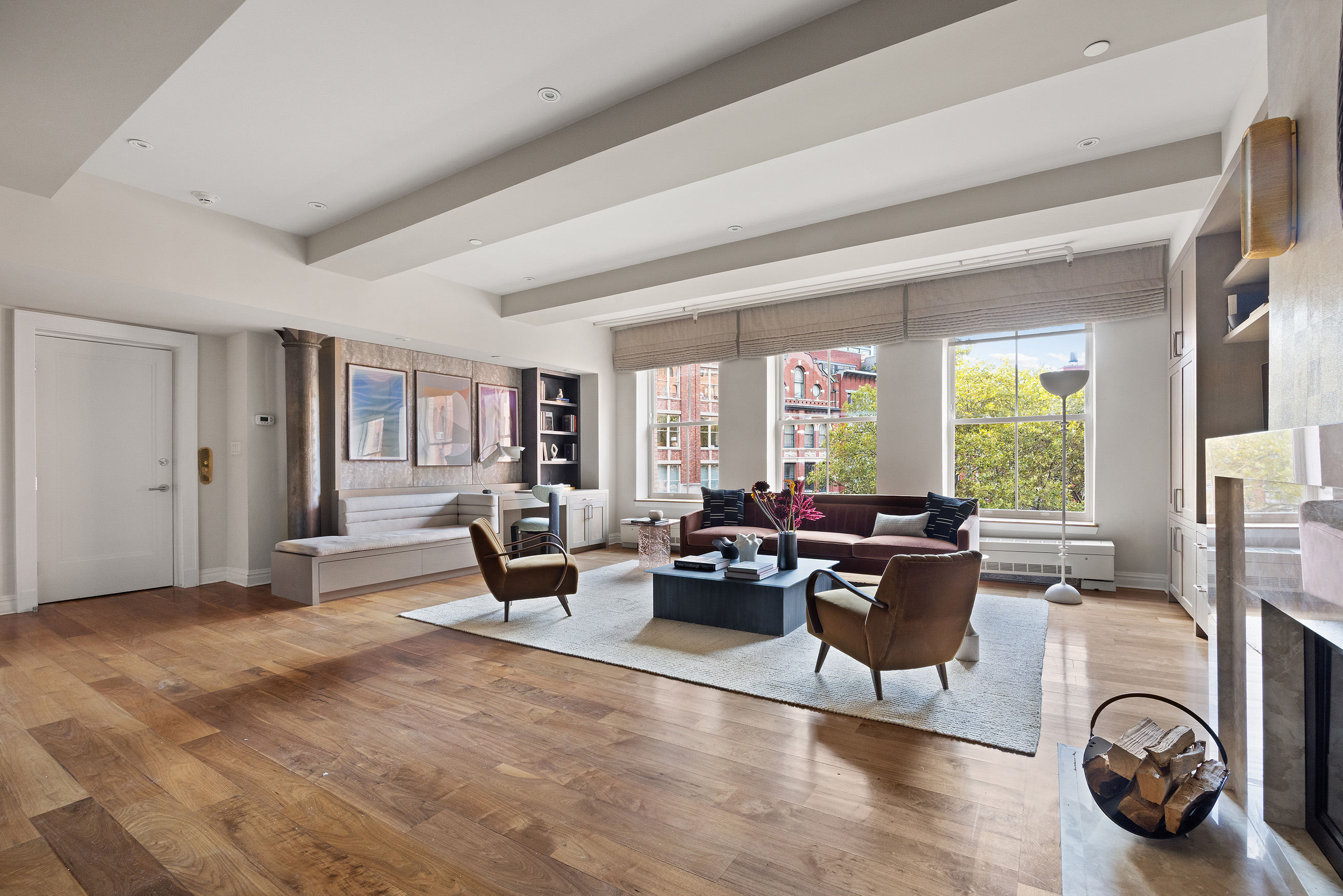 a living room with furniture large window and a fireplace