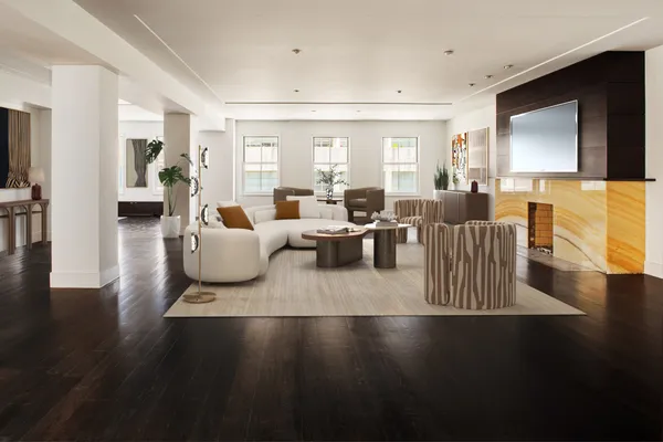 a living room with furniture wooden floor and a flat screen tv