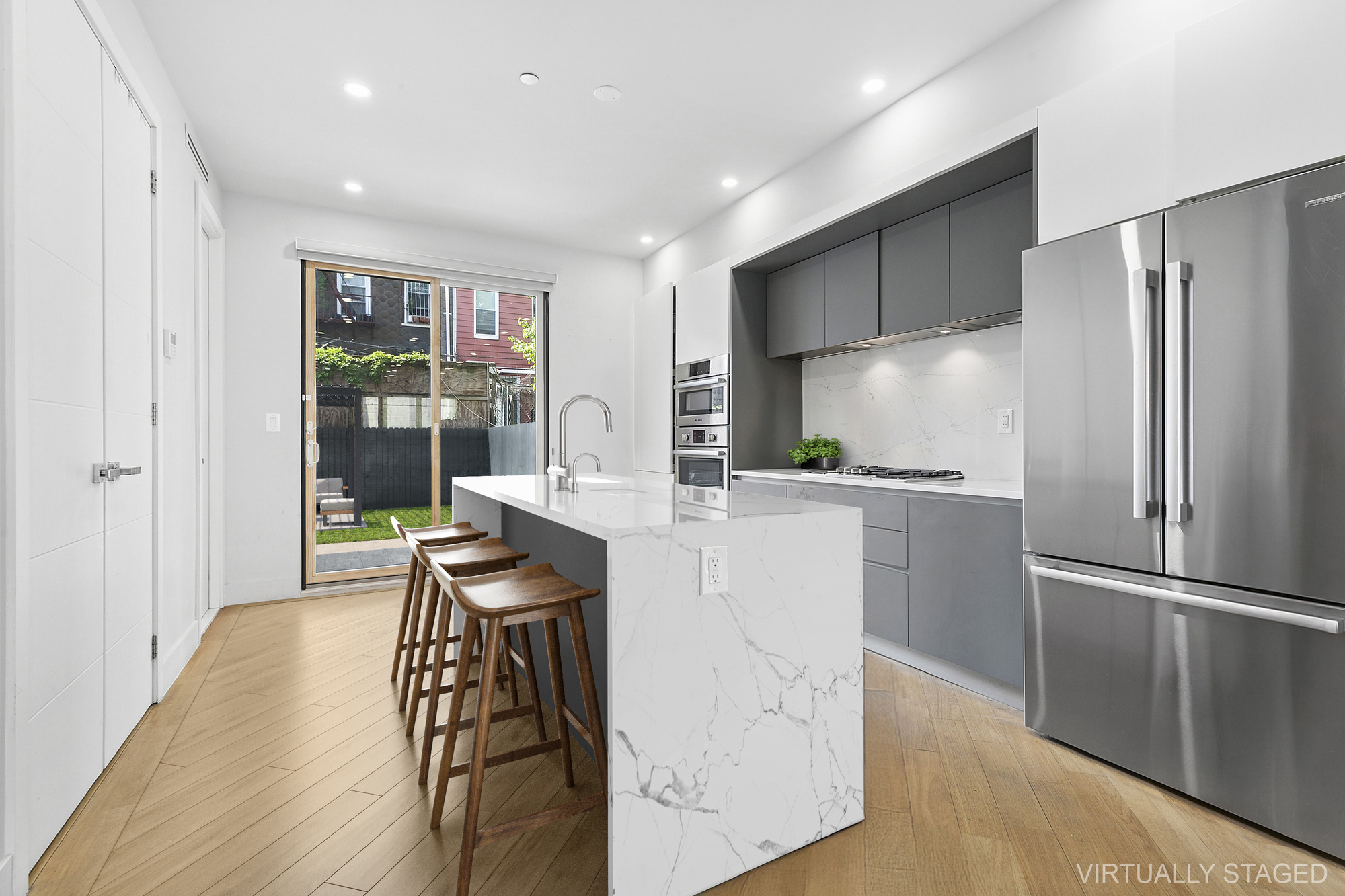 483 Hart Street, Unit 1 Brooklyn, NY 11221 - Photo 2 of 18 a kitchen with kitchen island a counter top space a sink appliances and cabinets