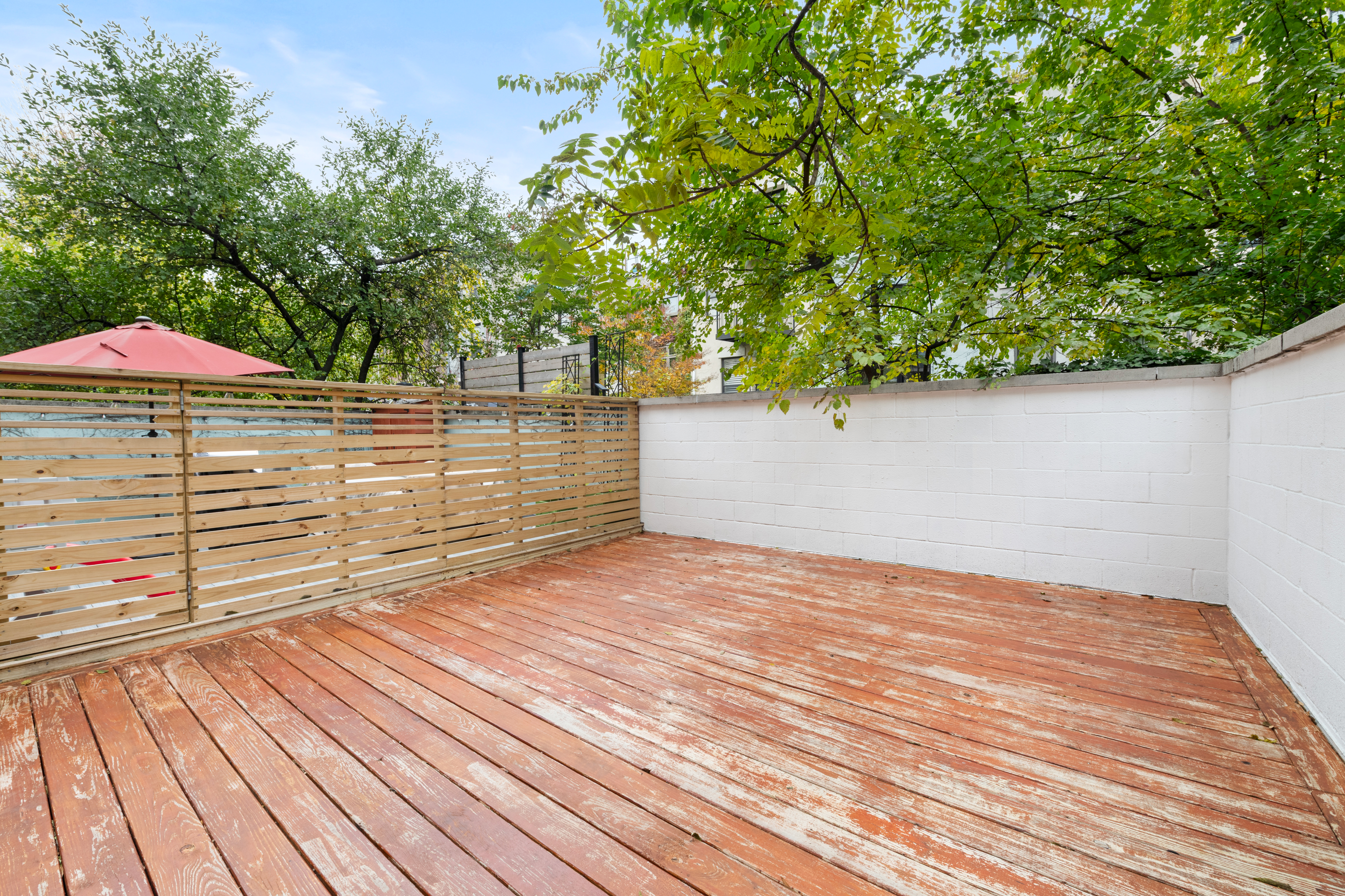 121 West 131st Street, Unit 2 Manhattan, NY 10027 - Photo 10 of 14 a view of a terrace with wooden floor and fence