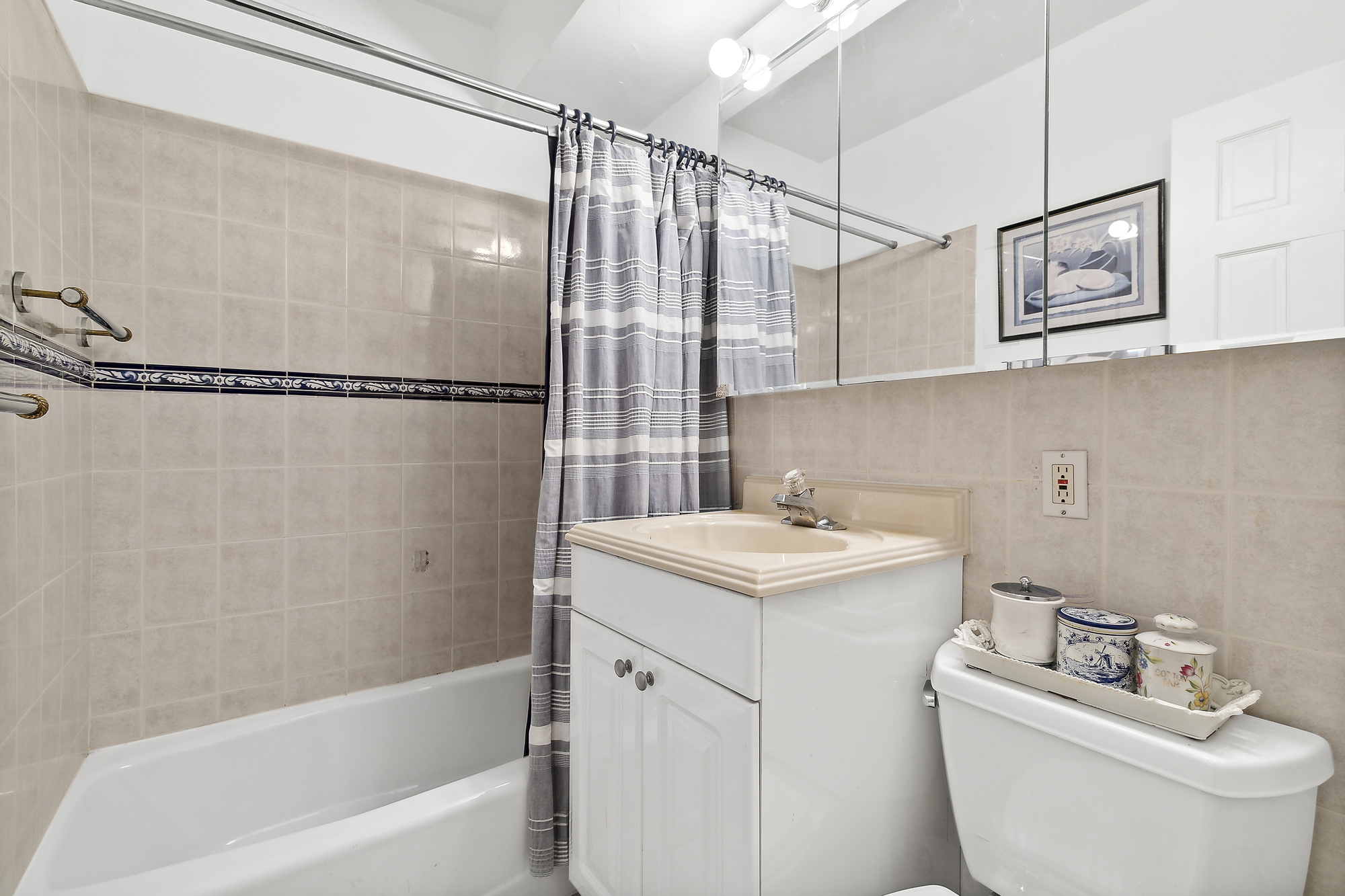 311 East 71st Street, Unit 2D Manhattan, NY 10021 - Photo 6 of 8 a bathroom with a sink toilet and shower