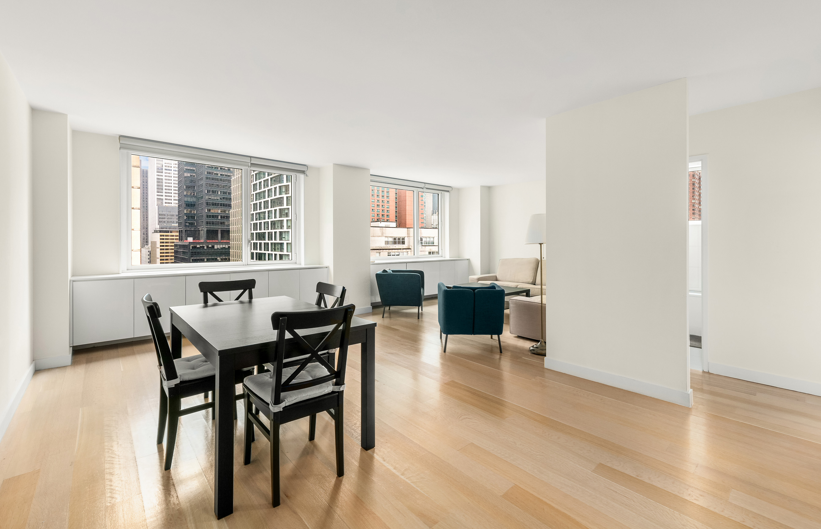301 West 53rd Street, Unit 19K Manhattan, NY 10019 - Photo 2 of 8 a view of a dining room with furniture and wooden floor
