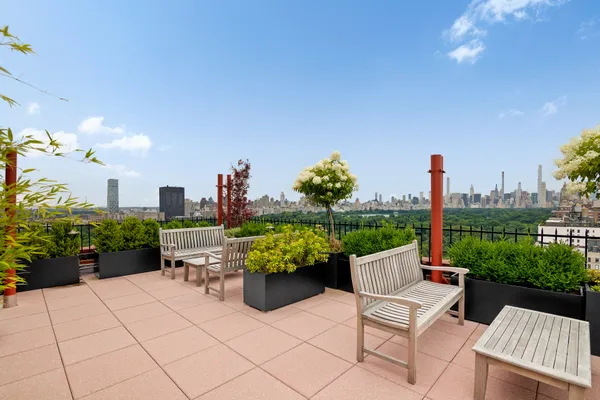 a view of a patio with a table and chairs and potted plants