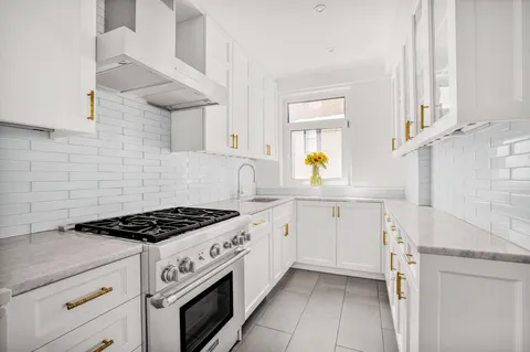 a kitchen with cabinets and appliances