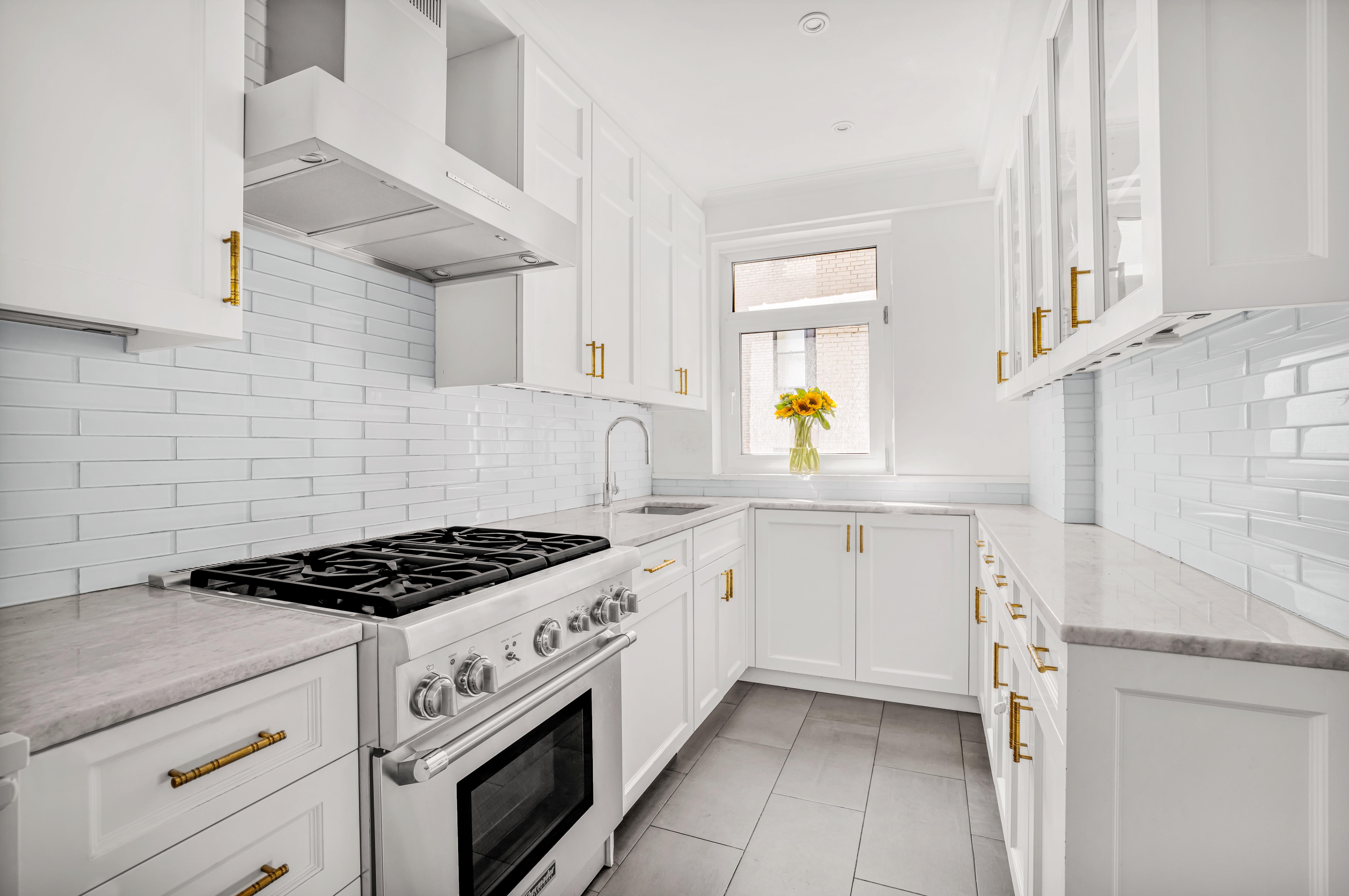 120 East 79th Street, Unit 7BC Manhattan, NY 10075 - Photo 4 of 12 a kitchen with cabinets and appliances