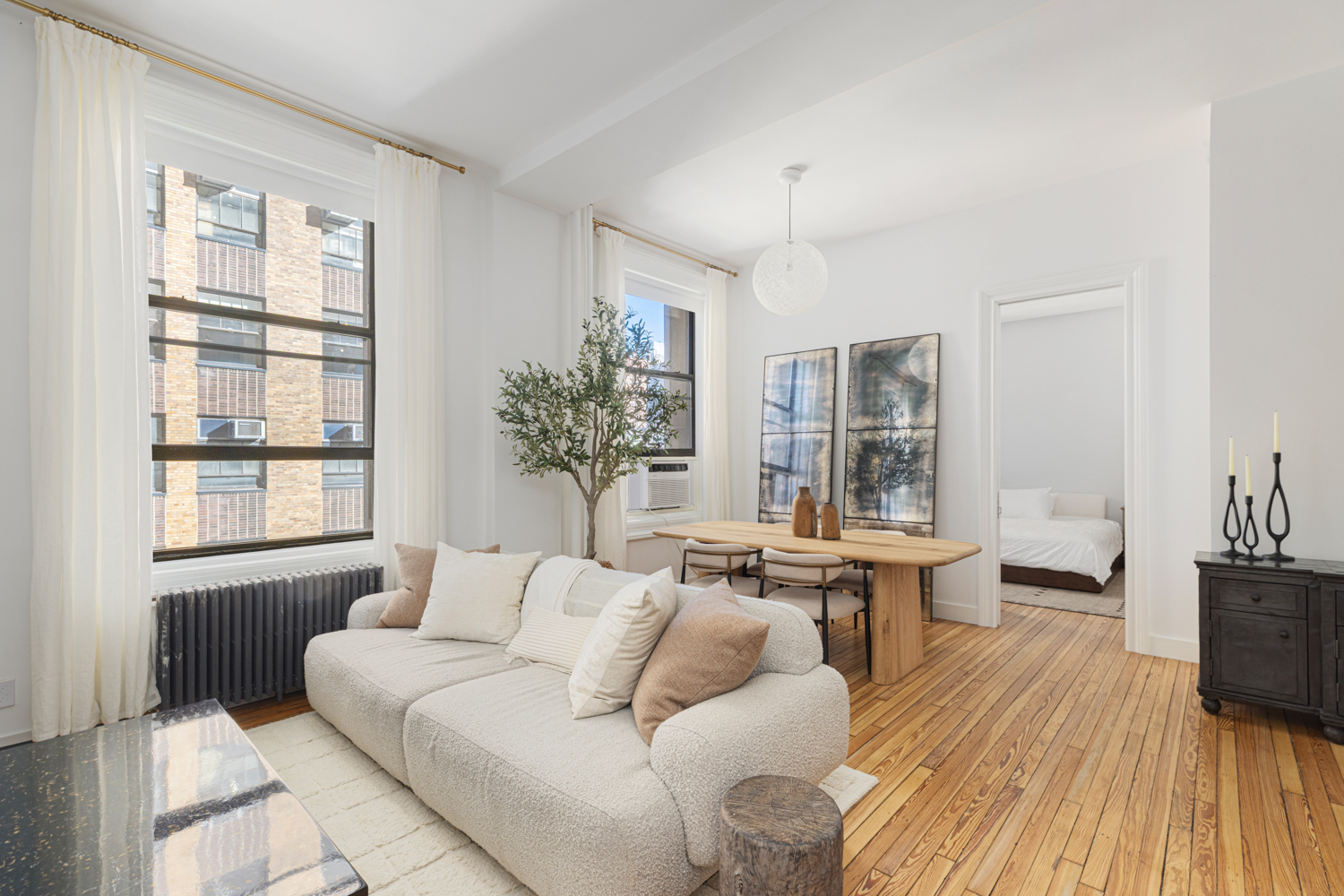 395 Broadway, Unit 5B Manhattan, NY 10013 - Photo 1 of 13 a living room with furniture and a large window