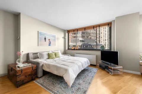 a bedroom with a bed and a desk